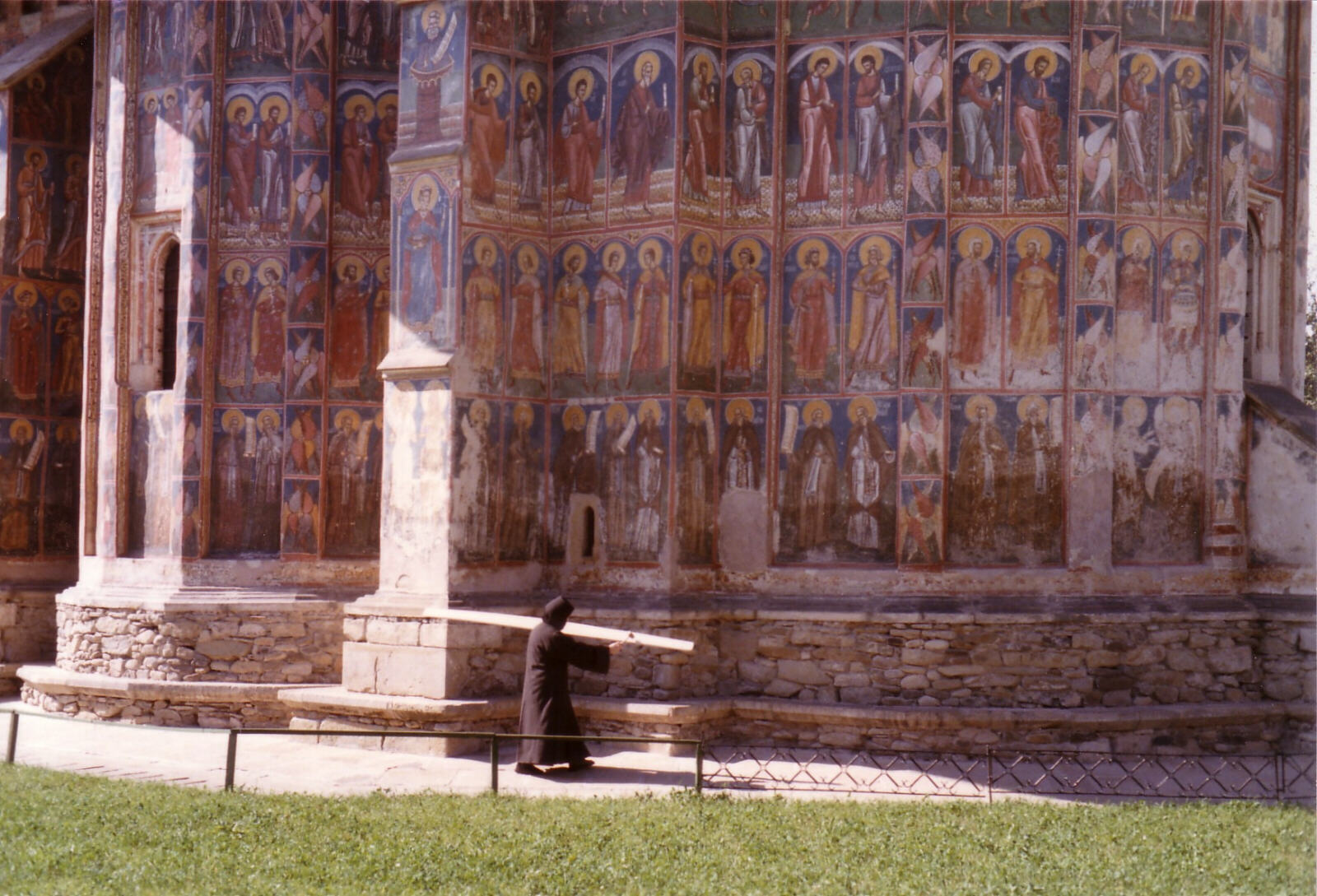 Sounding the Tawaca to scare the vampires at Moldovita monastery in Bucovina, Romania