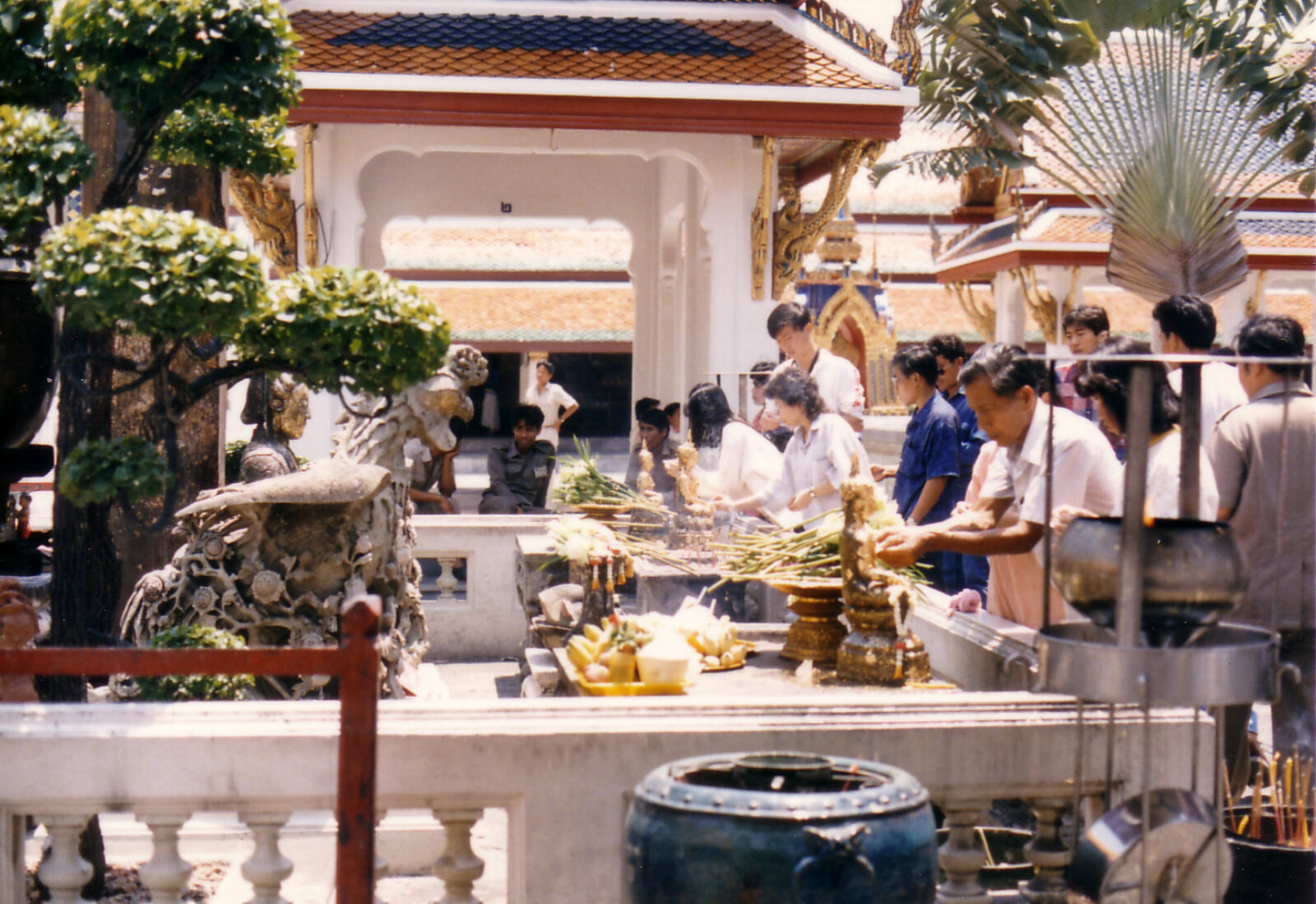 Lighting incense sticks at Wat Pra Kheo, Bangkok