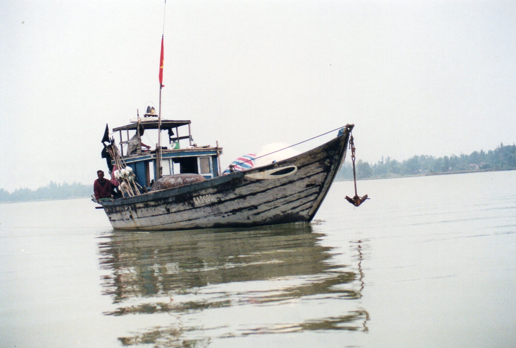 A wooden boat on the Thu Bon river in Hoi An, Vietnam