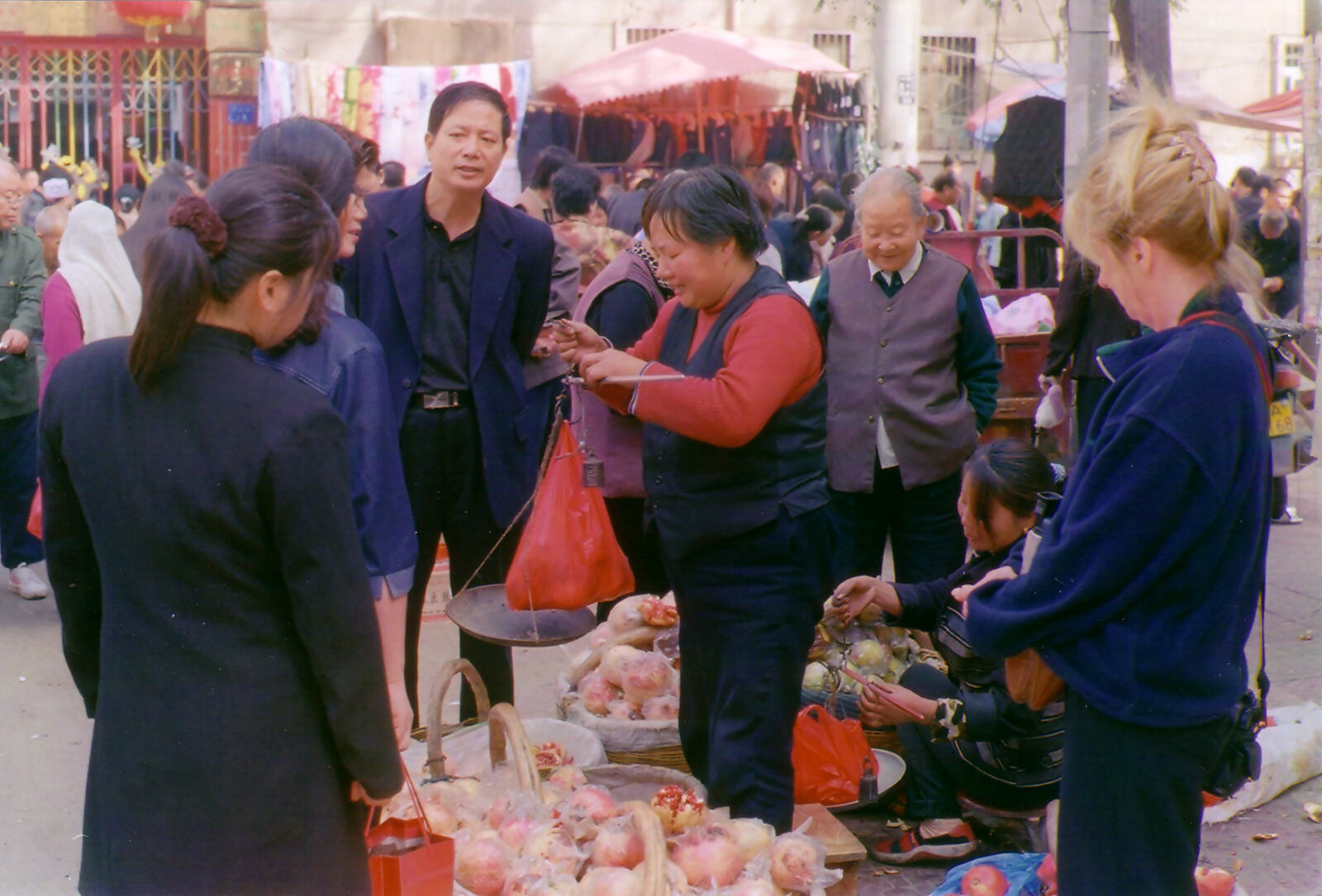 Weighing out pomegranates in the Islamic market in Xian, China