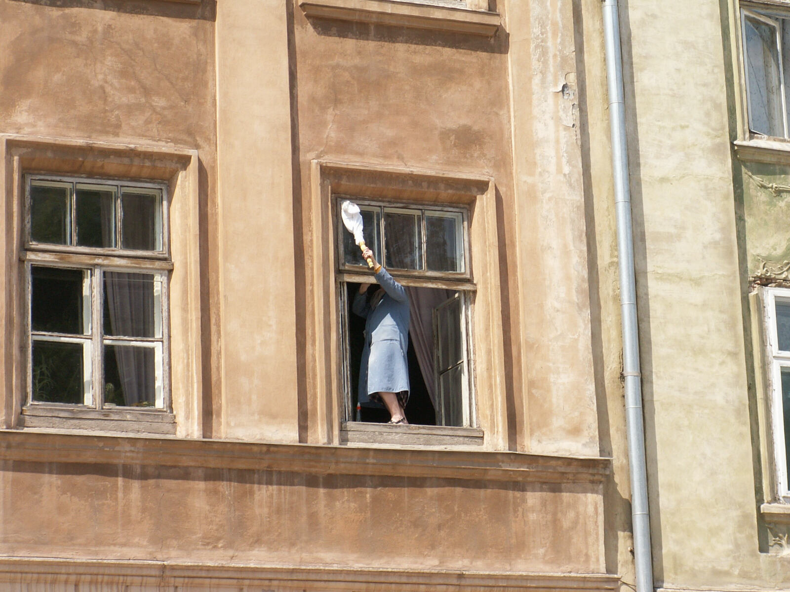 Window cleaning on Rynok Street in Lviv, Ukraine