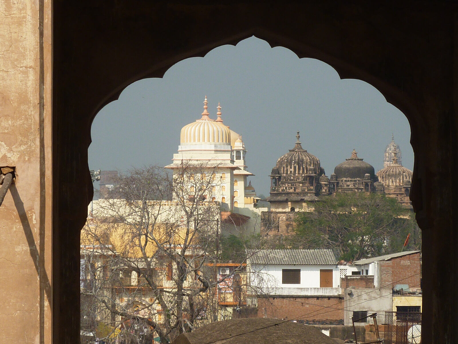 The domes of Orchha seen through a gateway, India