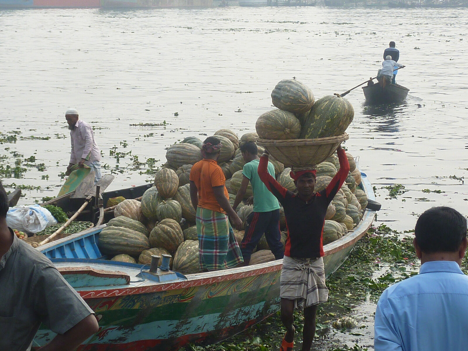 Unloading vegetables from riverboats at Sadar Ghat, Dhaka