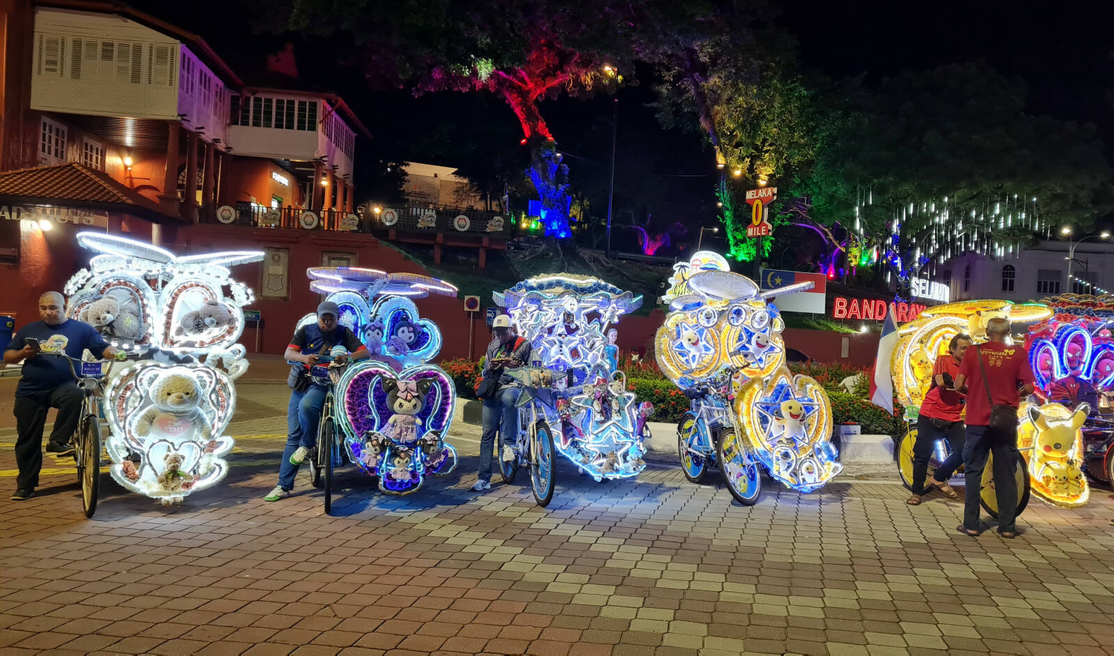 Bright and noisy cycle rickshaws in the town square in Malacca, Indonesia