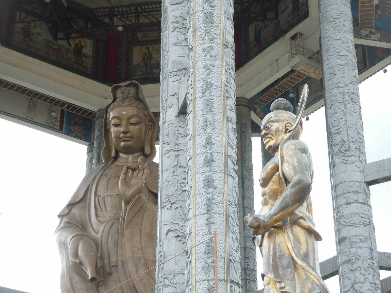 Kuan Yin, the goddess of compassion, and a guardian demon at Kek Lok Si temple, Penang, Malaysia