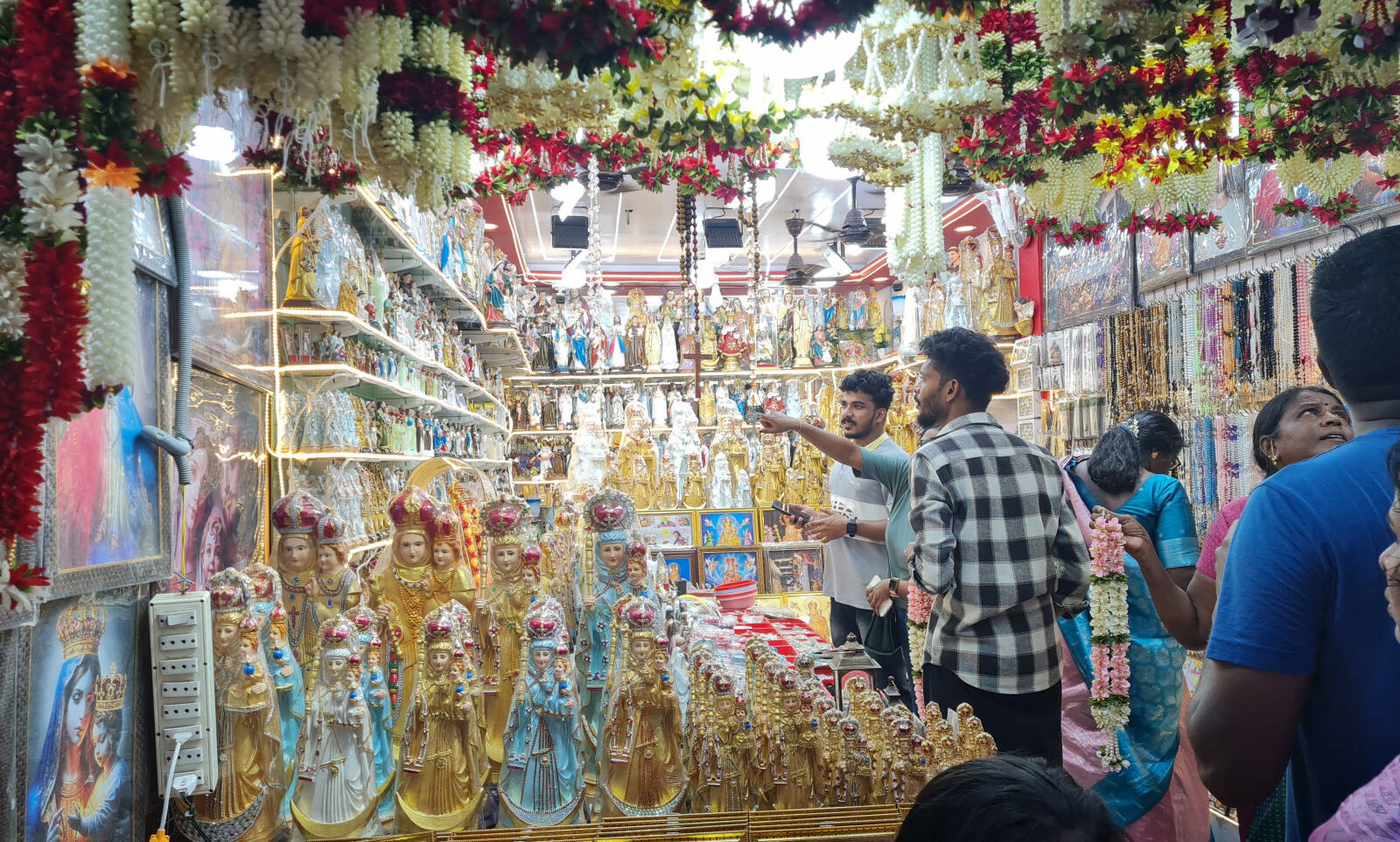 Shop for religious artefacts in the street to the Basilica in Vailankanni, Tamil Nadu, India Shop for religious artefacts in the street to the Basilica in Vailankanni, Tamil Nadu, India