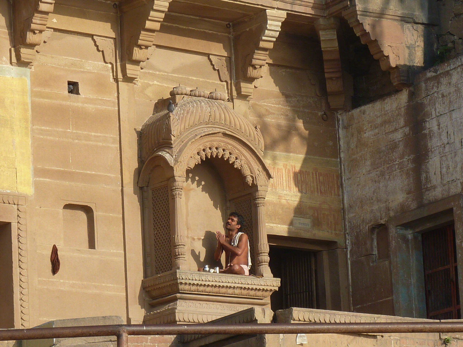 A morning worshipper in a window in Varanasi, India in 2014